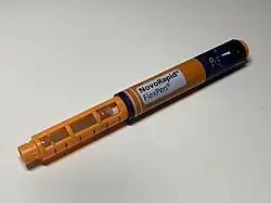 uncapped orange insulin pen labelled Novorapid