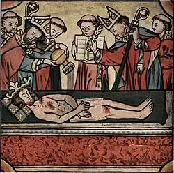 A crowned and bearded dead man lying on a stone is surrounded by two bishops and five monks