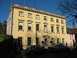 Three-storey yellow-coloured house in the Palladian style