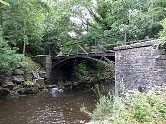 Iron Tram Bridge, Robertstown is an early example of a "railway" bridge. It crosses the River Cynon between Trecynon and Robertstown. It carried the Llwydcoed Tramroad which ran from Hirwaun to the canal head at Cwmbach, south east of Aberdare. It wa