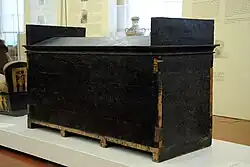 Black rectangular wooden box with vaulted lid
