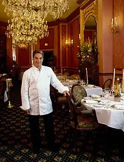 Georges Perrier stands in a white chef's coat inside Le Bec-Fin.