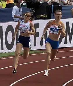 Photo of Amandine Brossier and Femke Bol running in a bend of the tracks