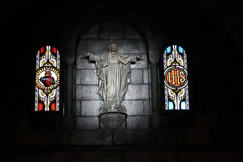 Stained Glass and statue of Christ in the crypt