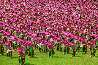 Balinese Tari pendet, performed by hundreds of dancers.
