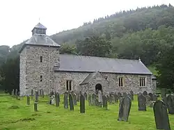 A medieval stone church surrounded by graves