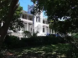 Image of the Peter Clarke Art Centre, a white, double-story building with arches.