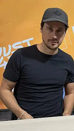 Peter Gadiot speaking on a panel at Torino Comics in April 2024