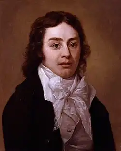 Head and shoulders portrait of a young man with short sideburns. He wears a high collar with a small bow and a coat, and is looking at the viewer.