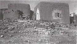 Lajjun, 1924. Half-buried Roman or Byzantine columns and modern huts (Rockefeller Museum).