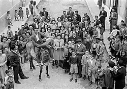 gathering of well-dressed people in a black-and-white photo from 1948