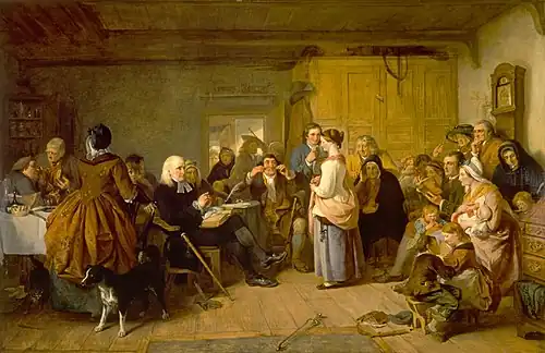 A room full of people seated with one woman standing. A minister is asking her questions.