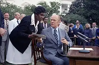 Jordan appears to be leaning towards Ford and speaking to him as he turns towards her