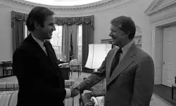A monochrome image of Carter shaking hands with Joe Biden