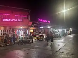 A photograph of various pupuserías at night
