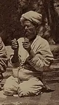 Musician plays a pair of qairaq in each hand