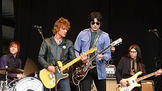 The Raconteurs performing at T in the Park, July 2008. Left to right: Patrick Keeler, Brendan Benson, Jack White, and Jack Lawrence.