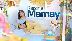 An image of Ai-Ai delas Alas lying on Shayne Sava's lap. The series title is displayed on the upper side of the image. The logo of GMA Network is displayed on the upper right side of the image.