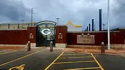 Black and white photo of a crowd looking at a field in front of a building that says Bellevue