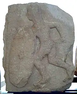 A black and white photograph of an apparently very old and crude bas-relief of a warrior