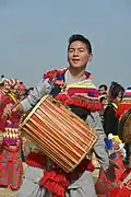 A Rai man playing traditional drum (Dhol)