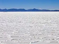 Hexagonal formations on the surface of the Salar de Uyuni as a result of salt crystallization from evaporating water