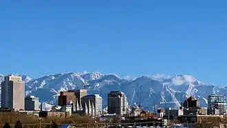 View of a city with snow-capped mountains in the background