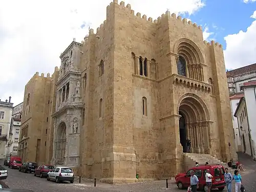Coimbra Cathedral, with crenellated tops and heavy buttresses giving it a castle like appearance.