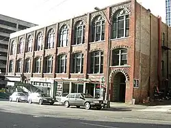 The Scheuerman Block is an example of the Victorian interpretations of the Romanesque Revival frequently applied to buildings erected shortly after the Great Seattle Fire