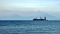 A container ship, Selatan Damai, anchored off Dili, Timor-Leste, in 2018 with Atauro in the background