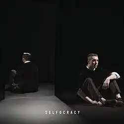 Nottet laying on the ground in front of a mirror, with his reflection being visible.
