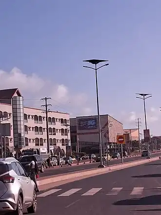A sandy beach with a small The Gambian flag in the foreground./ The golden sun in Serekunda in The Gambia in West Africa