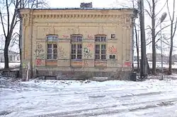 Old and abandoned brick building with graffiti and snow.