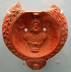 Oil lamp with a bust of Serapis, flanked by a crescent moon and star (Roman-era Ephesus, 100–150)