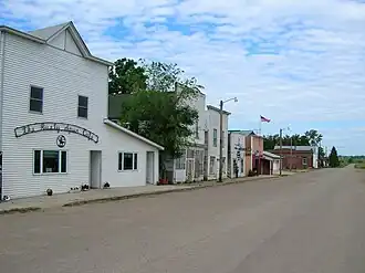 The white storefronts in Kathryn have been preserved close to their historic 1900s state.