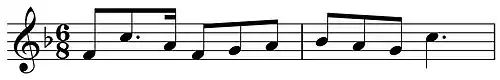 Musical notation showing a theme in F and in 6/8 time on a treble clef.
