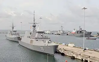 RSS Tenacious docked behind RSS Steadfast in Changi Naval Base during CARAT 2015.