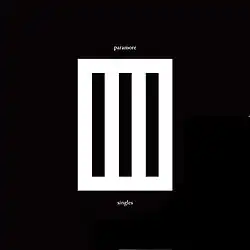 A white rectangle in the middle of a black background. The rectangle contains three black, vertical bars. "paramore" is written in white text above the rectangle and "singles" underneath it.
