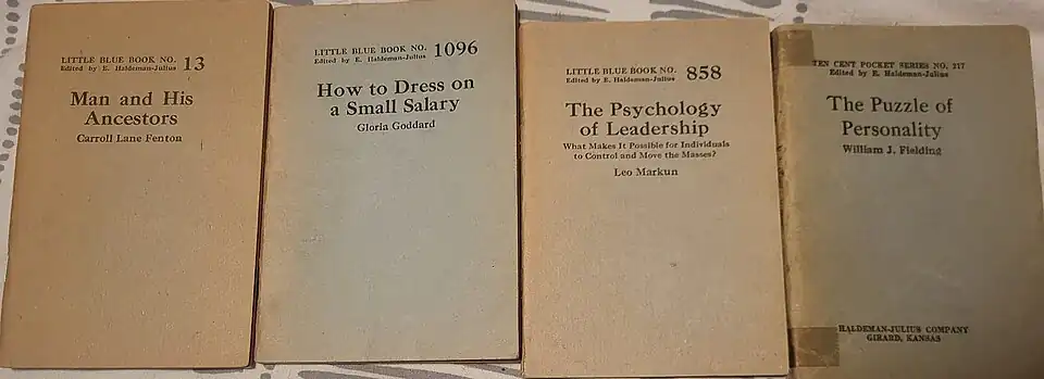 A picture of four Little Blue Books: Man and His Ancestors, How to Dress on a Small Salary, The Psychology of Leadership, and The Puzzle of Personality.