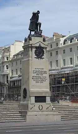 Bronze statue of a soldier atop a decorative plinth