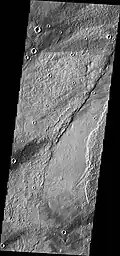 Southern end of Enipeus Vallis is about 10 km wide and broadly U-shaped in profile. The western wall of the valley has a straight NE orientation similar to that of fractures in the Noachian plateau materials to the east. This suggests that the valley formed along pre-existing faults. (THEMIS VIS image)