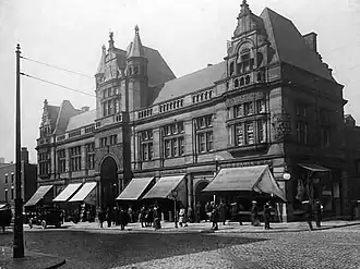 frontage of a brick building with terracotta decoration and several turrets
