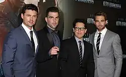 Four young men in suits