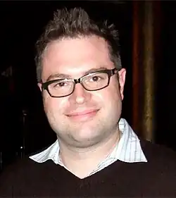 A smiling, bespectacled Steven Page