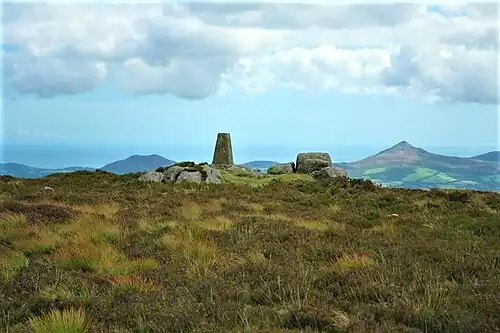 Summit triangulation pillar. In the distance is the Great Sugar Loaf (right), and Little Sugar Loaf (left)