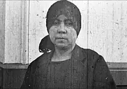 Teresa Flores wears a black headscarf during the funeral of her partner Luis Emilio Recabarren