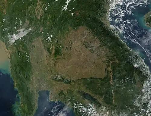 A view of Southeast Asia (Myanmar, Thailand, Laos, Cambodia, Vietnam, and southern China) from space, showing a large, central brown patch in the area of Thailand.