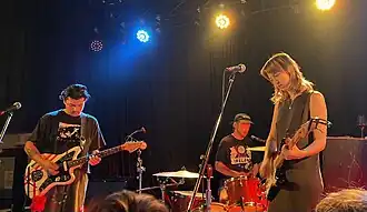 From left: Mike Bradvica, Daniel Devlin and Maisie Everett performing in 2024.