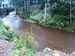 The Eau Rouge river as it passes the interior of the Circuit de Spa-Francorchamps, close to the pit complex