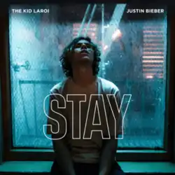 High-contrast image of young man, face tilted upwards, in front of a window, with hollow capital letters "STAY" front and center